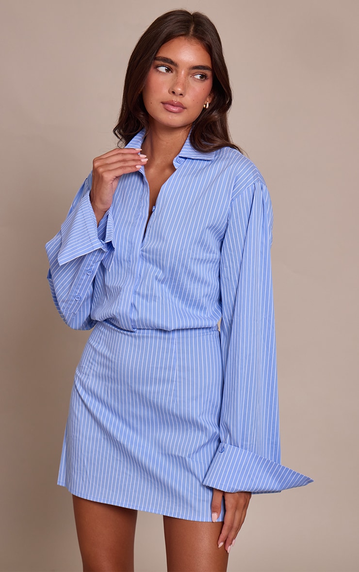 https://cdn-img.prettylittlething.com/9/b/9/c/9b9c467a1b338f379a10b7f77ebaec0545c61143_CNO3528_3_blue_pinstripe_button_down_shirt_dress.jpg